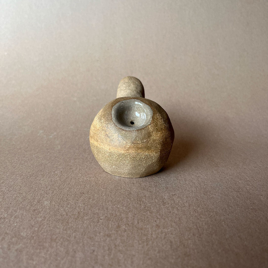 A gourd shaped, spherical body form in brown stoneware with hammered texture, featuring a large glazed inset bowl and rounded stem protrusion mouthpiece.