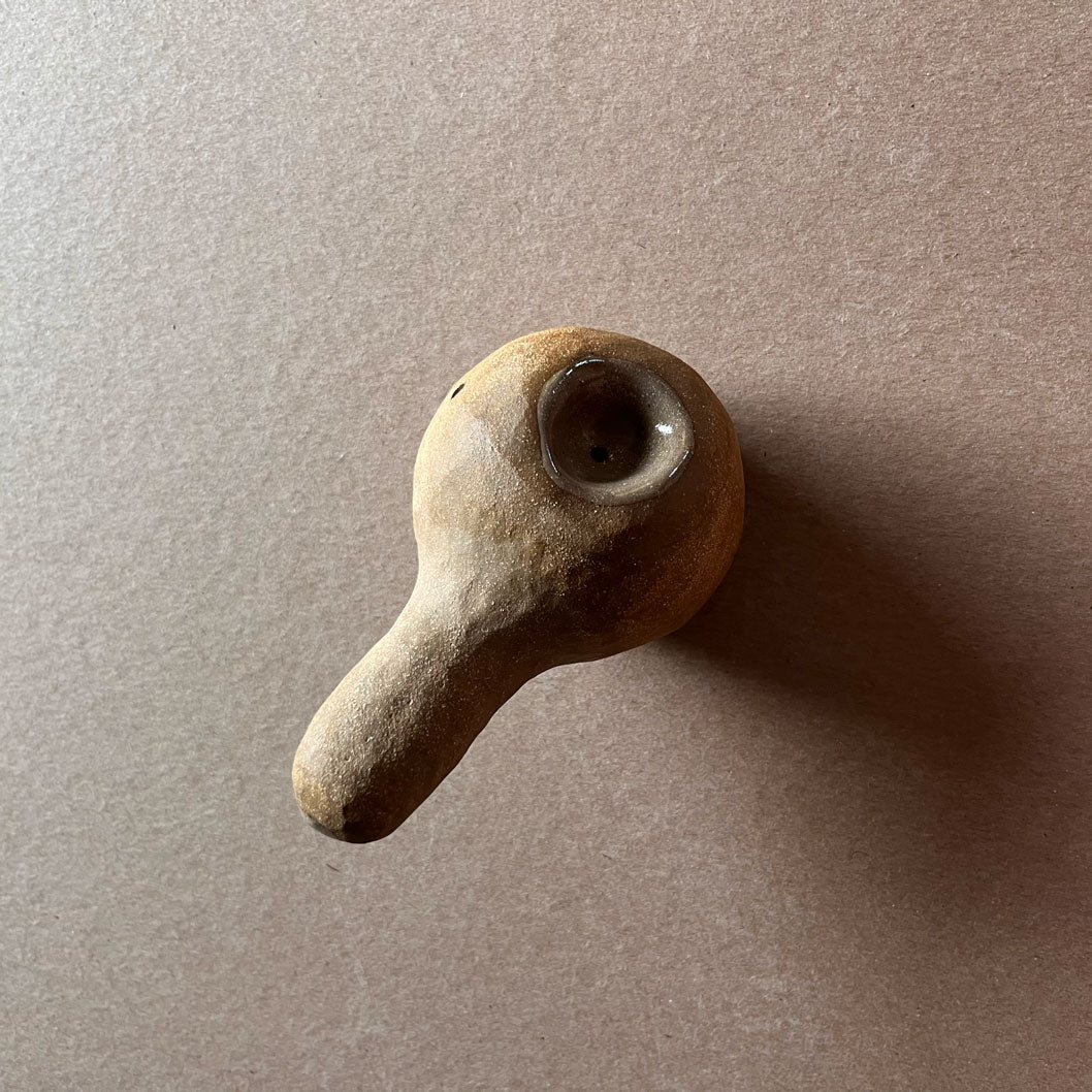 A gourd shaped, spherical body form in brown stoneware with hammered texture, featuring a large glazed inset bowl and rounded stem protrusion mouthpiece.