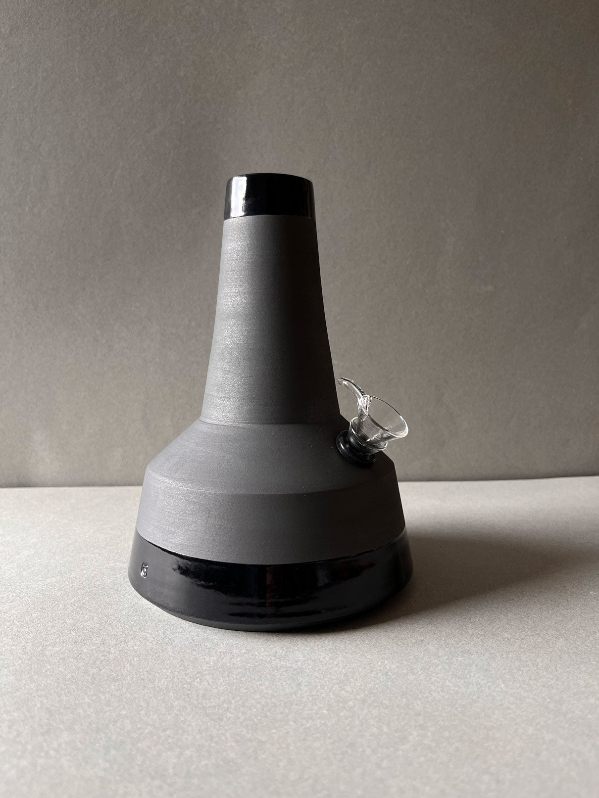 White stoneware, hand painted black matte exterior with a clear glazed interior, rim and base.