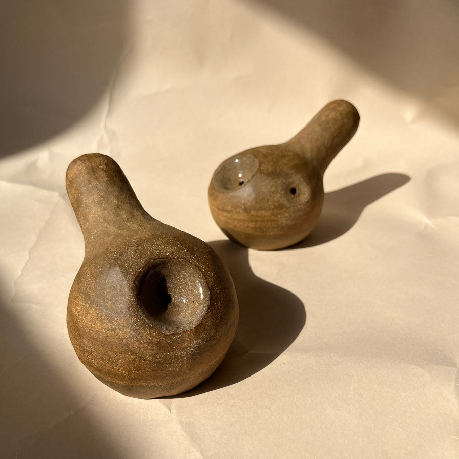 A gourd shaped, spherical body form in brown stoneware with hammered texture, featuring a large glazed inset bowl and rounded stem protrusion mouthpiece.
