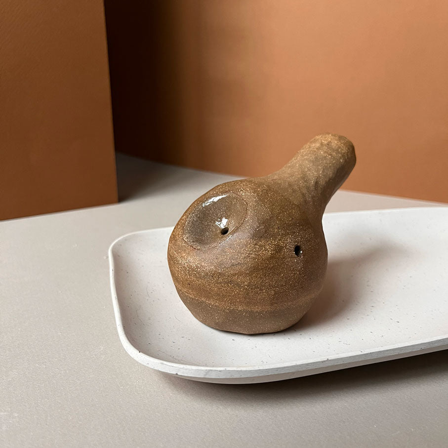 A gourd shaped, spherical body form in brown stoneware with hammered texture, featuring a large glazed inset bowl and rounded stem protrusion mouthpiece.