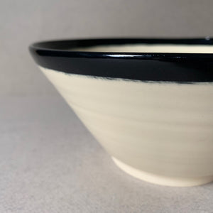 Black and white hand painted angled bowl, closeup