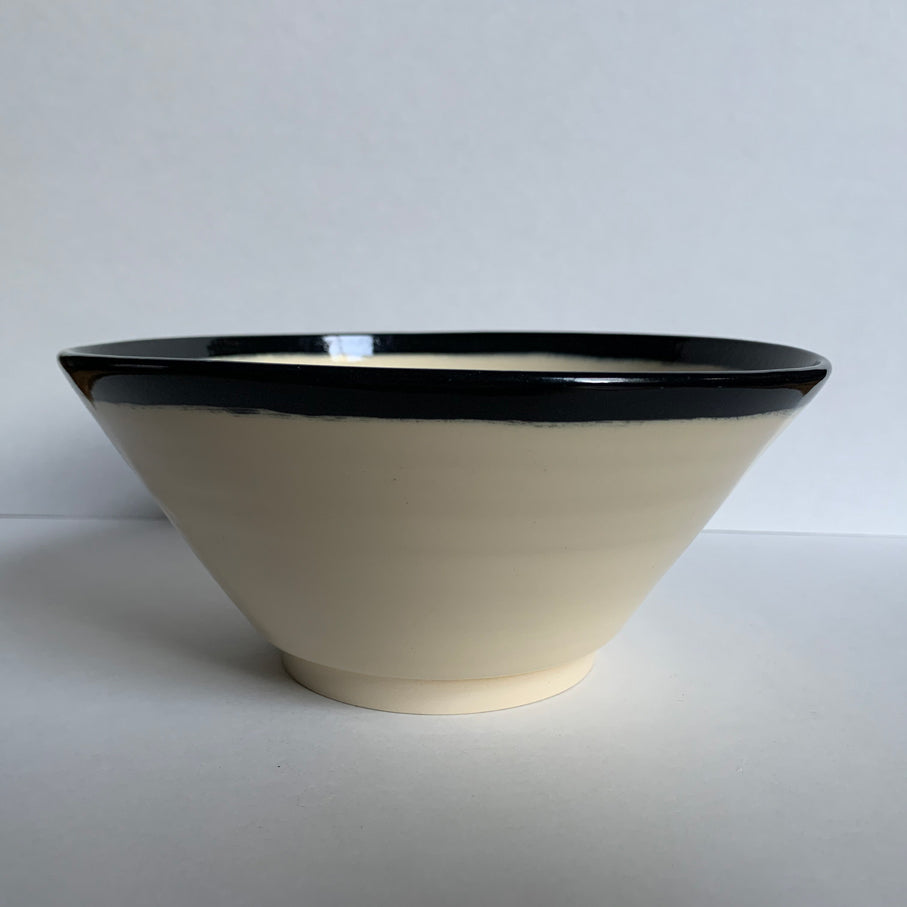 Black and white angled bowl, side view